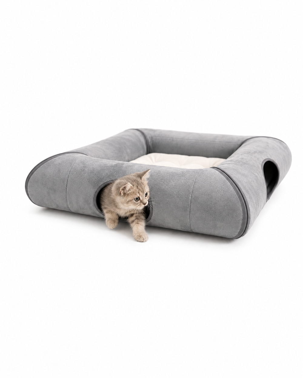 Kitten crawling through one of two opposite entrances in a gray foldable cat tunnel bed with a soft cushion