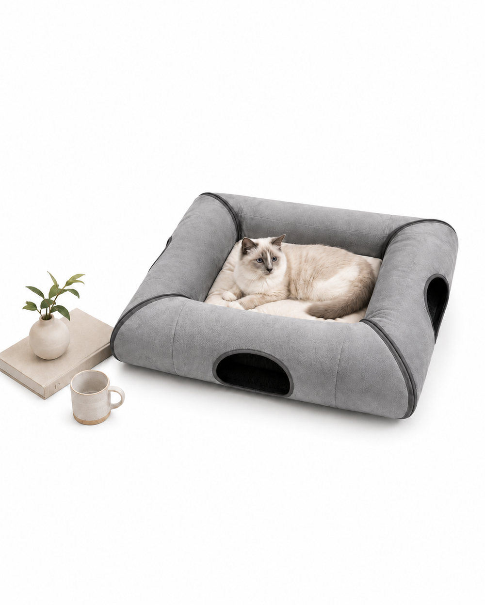 Gray foldable cat tunnel bed with a cat resting on the soft cushion in a minimalist home setting