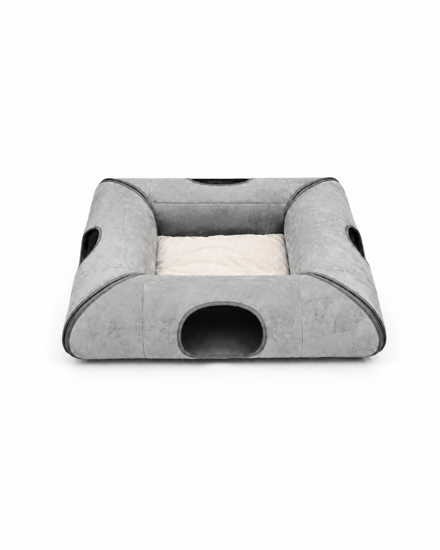 Cat resting on the soft center cushion of a gray foldable cat tunnel bed